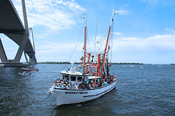 The Winds of Fortune sailing under the Ravenel Bridge during the Blessing of the Fleet.