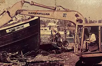 A caterpillar works at removing the remains of the trawler called Richard & Charlene.